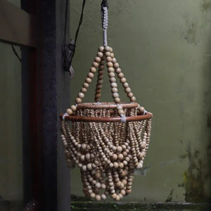 Handcrafted wooden bead chandelier with cascading natural beads, hanging indoors.