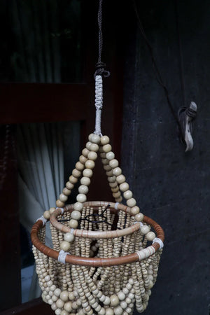 Handmade Balinese beaded chandelier hanging outdoors, eco-friendly boho home decor