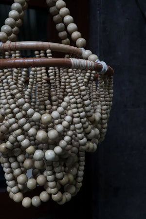 Handmade Balinese beaded chandelier with natural wooden beads and intricate hanging design