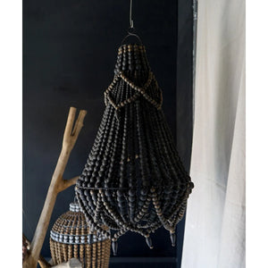 Handmade Balinese beaded chandelier with black wooden beads in rustic boho decor setting